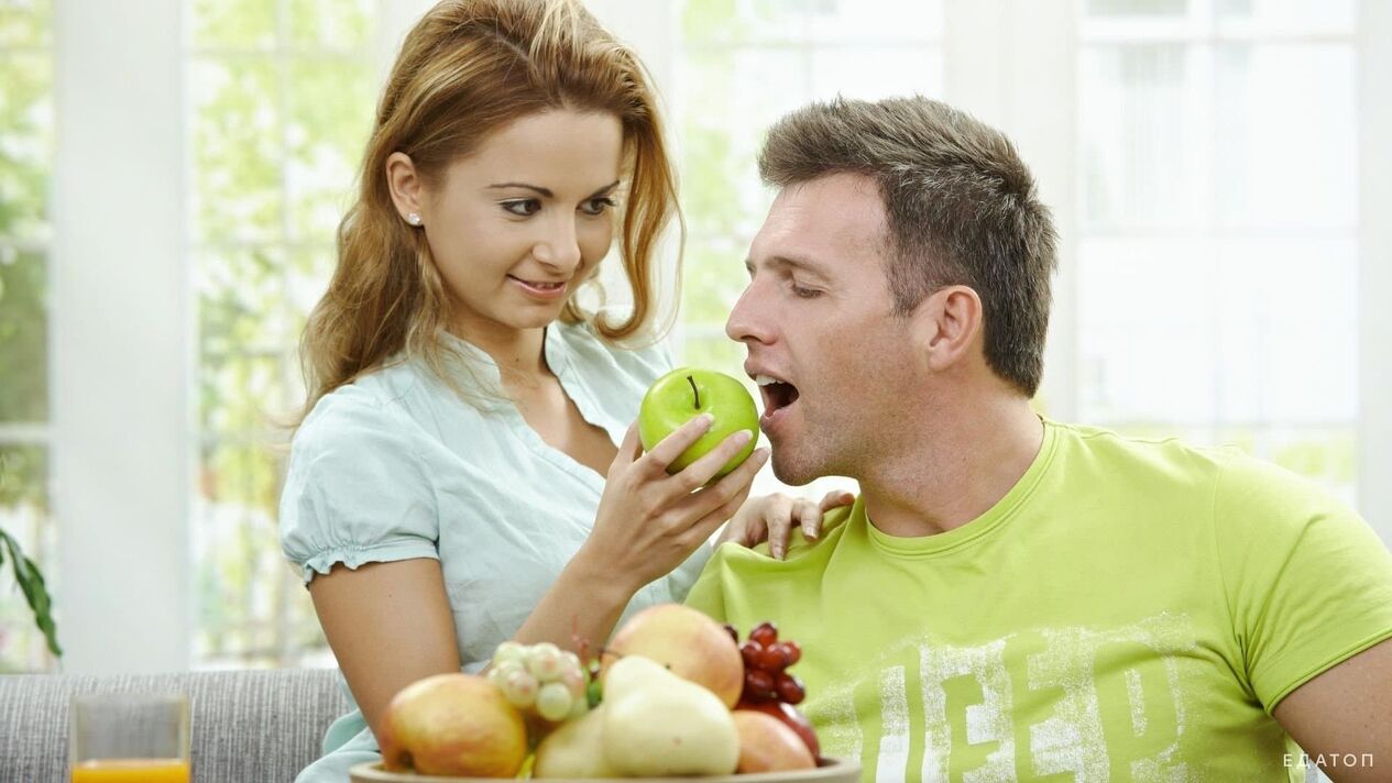 girl feeds a man with healthy food